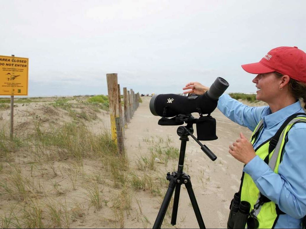 Kristen Vale pointing at yellow do not enter sign